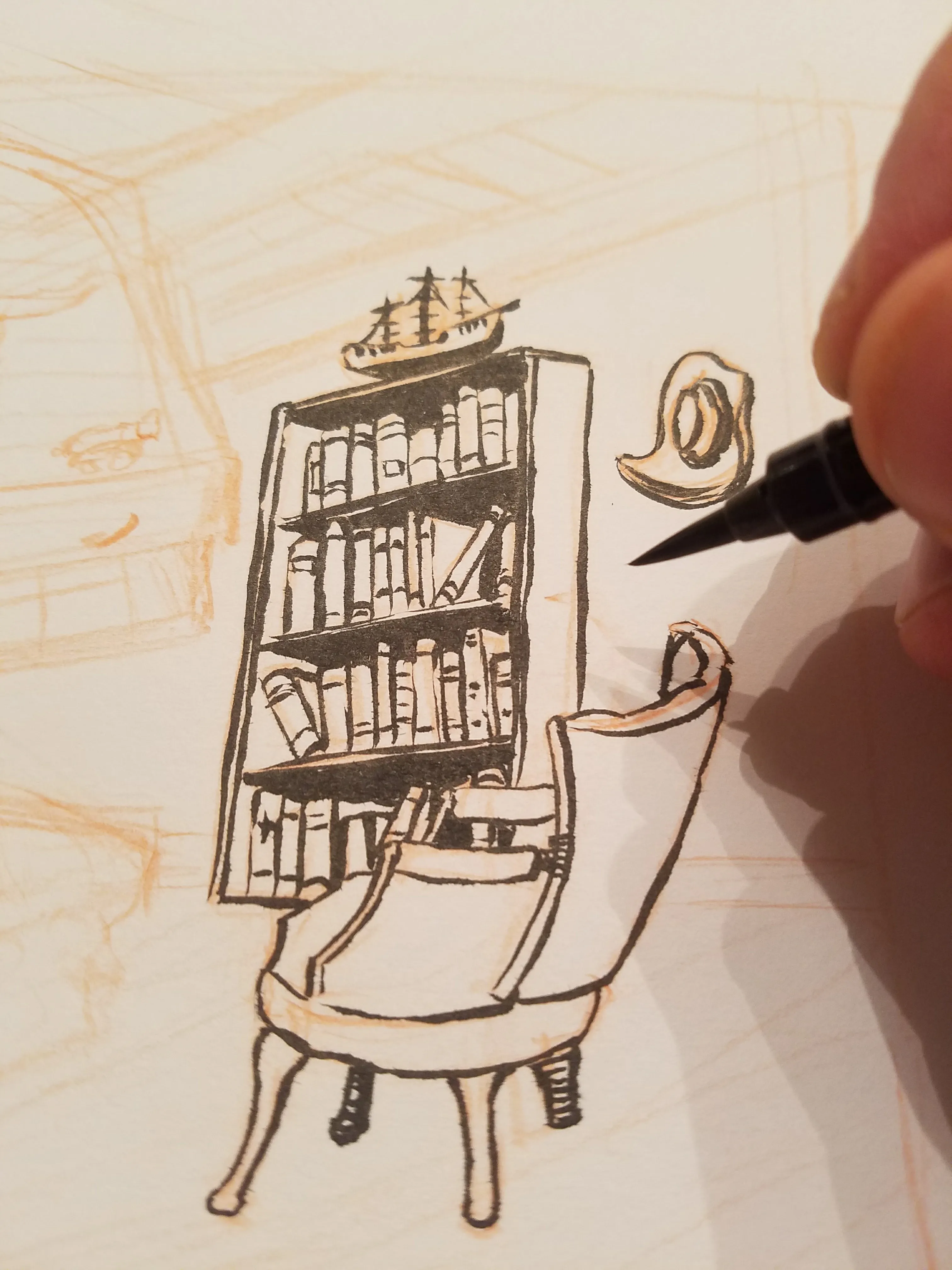 An in-progress ink drawing of a tall bookshelf and reading chair beside the artist's brush pen
